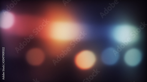 blurred bokeh lights background with multicolor circles and dark tones for abstract use
