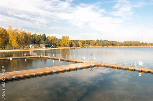 a bridge over the lake and fog over the water
