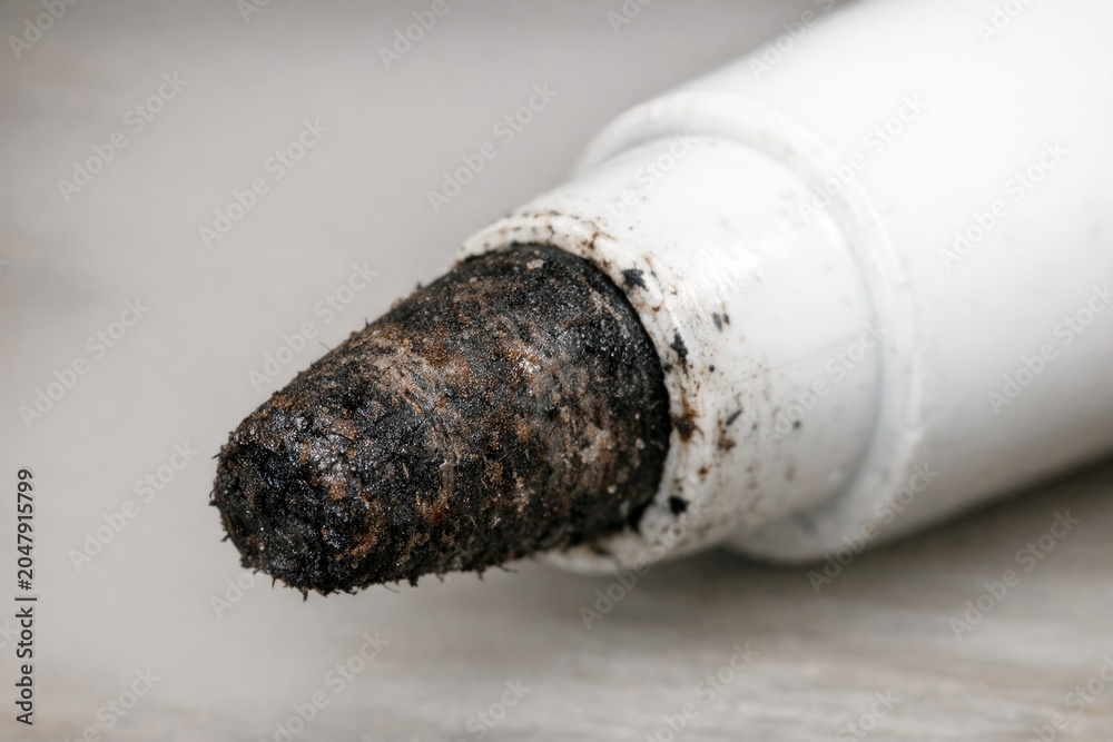 Obraz premium Close-up shot of a white pipe with dirt and debris accumulated on its surface
