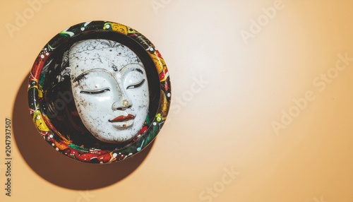 Tranquil asian visage encased in colorful adornments, set against warm backdrop