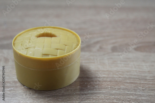 Round yellow box on a light background
