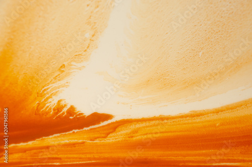 Sunset in warm colors over ocean waves with clouds in the sky during evening hours