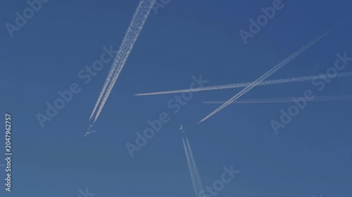 A composite of several jet aircraft crossing paths in a crowded sky
