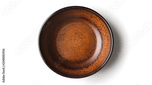 A brown ceramic plate with a textured surface and black speckles on a white background