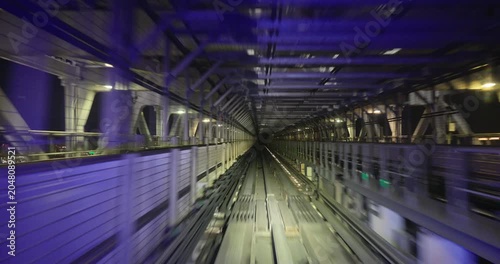 Train goes through city at night,  concept of speed, time lapse