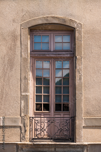 Принти на полотні Ancient stone wall frames a vintage wooden window, Carcassonne
