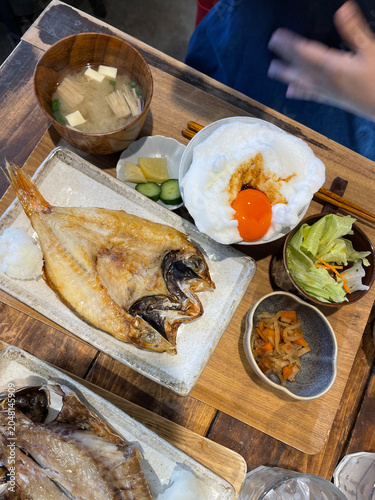 Quadro su tela Japanese grilled fish set meal with tamago kake gohan on table