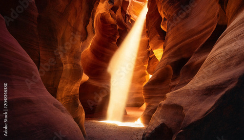 Cuadro en lienzo A narrow slot canyon with smooth orange sandstone walls and a single bright beam