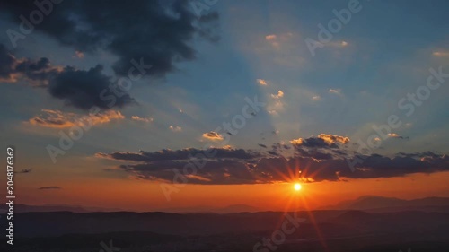 Dramatic Sunset Over Ocean Horizon with Golden Clouds and Radiant Sunlight