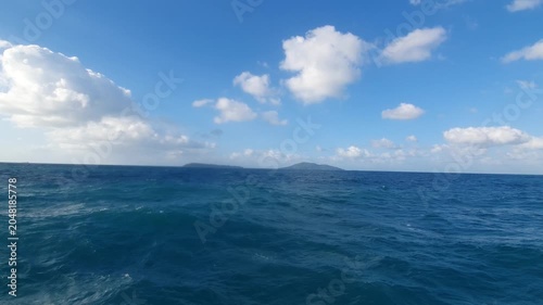 various shapes of clouds in the sky above the choppy sea