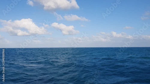 various shapes of clouds in the sky above the choppy sea