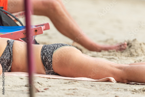 Canvas Print Tourists relaxing sandy beach during seaside vacation Leisure travel lifestyle f