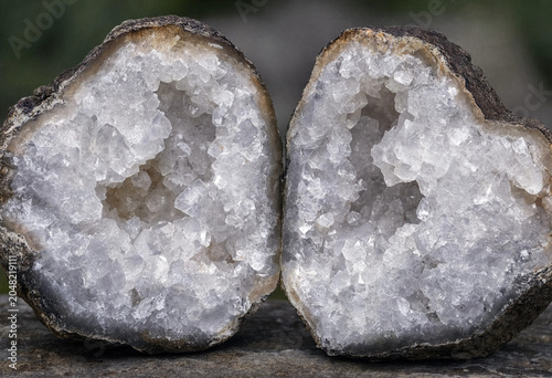 Photos Two halves of a split geode showing sparkling white quartz crystals inside a rou