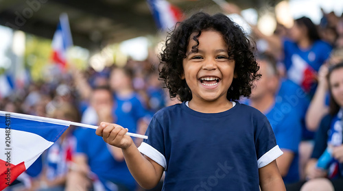 Happy young child waving a french flag at a sporting event