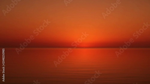 Sunset over calm sea water.