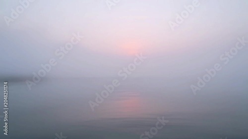 Sunset over calm sea water.