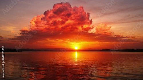 Sunset over water with clouds.