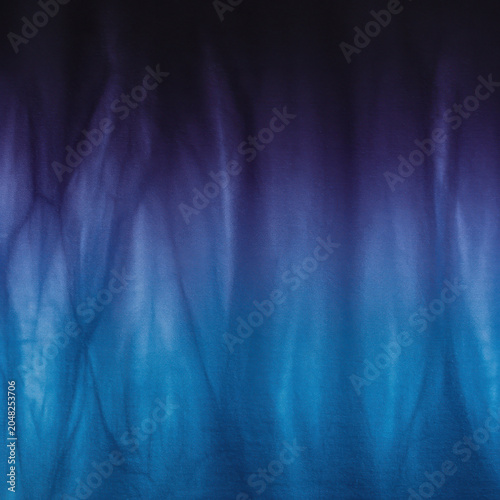 Abstract blue and purple fabric surface with dip dye gradient effect for textile design, fashion editorial background and artistic creative template