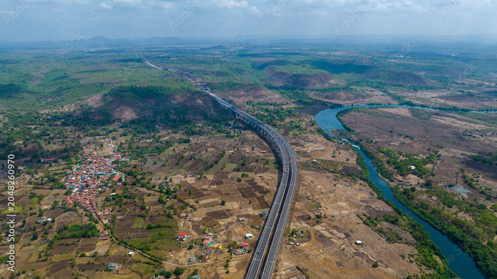 Fototapeta premium Samruddhi Mahamarg expressway aerial photography Maharashtra India Drone shot of Samruddhi Mahamarg highway through rural landscape