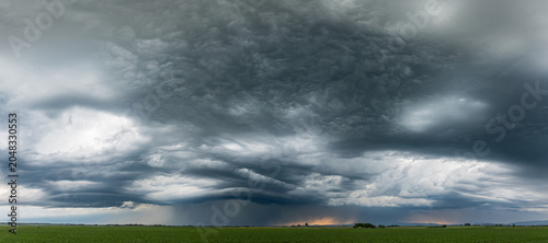 Heavy storm clouds and threatening thunderclouds stretch across the Bavarian sky, capturing a dramatic meteorological moment in the picturesque landscape of southern Germany