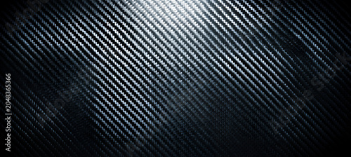 Diagonal textured surface with a carbon fiber-like appearance, a subtle gradient of light to dark, creating a sense of depth and dimension