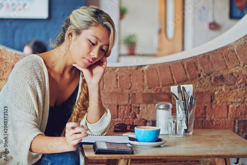 Photography Planning, remote work and woman with tablet in coffee shop, reading feedback and research for script