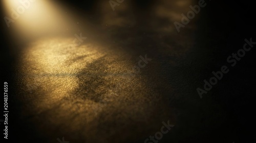 Golden light beam on dark textured background with abstract glow.