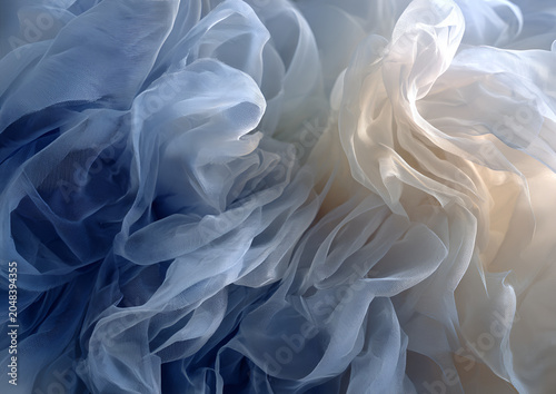 Soft, flowing fabric in shades of blue and cream creates an abstract composition. Light and shadow interplay. Gentle, airy, elegant