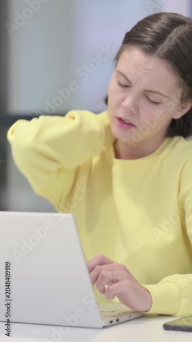 Young Woman having Neck Pain while using Laptop in Office, Vertical Video