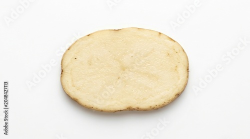 Raw potato slice isolated on white background, fresh organic vegetable cross section, round starchy potato piece for cooking and food design