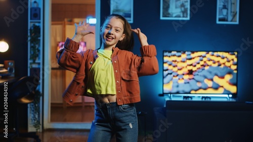 Kid influencer having fun dancing in home studio  recording video for generation z internet users. Girl doing skillful dance moves  following online choreographic trends from favorite celebrities
