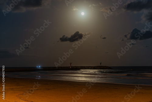 Full Moon Over Calm Nighttime Beach Waters