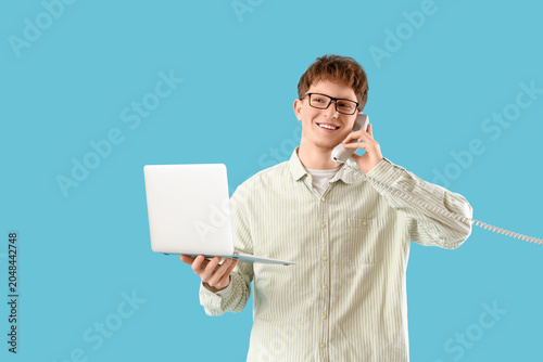 Young man with laptop talki...