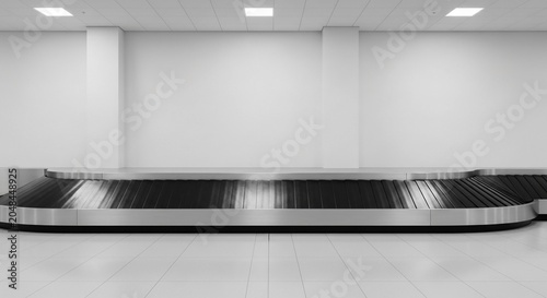 Minimalist black and white airport baggage carousel waiting area with empty conveyor belts