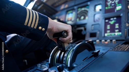 Commercial Airline Pilot Hand Controlling Thrust Levers in Modern Aircraft Cockpit