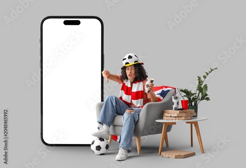 Canvastavla Displeased female African-American soccer watching game and big mobile phone wit