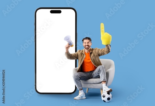 Male soccer fan with megaph...