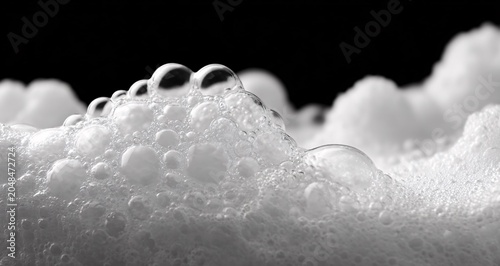 Soap bubbles clustered on foamy surface in closeup