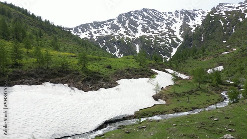 Europe, Italy, Alpeggio Balma di Rodoretto , Prali , Turin is a small mountain village with a stream of water due to the melting of the glacier ice - climate change and global warming save the planet
