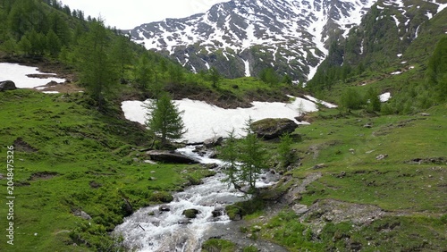 Europe, Italy, Alpeggio Balma di Rodoretto , Prali , Turin is a small mountain village with a stream of water due to the melting of the glacier ice - climate change and global warming save the planet