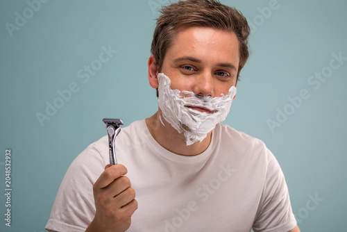Photos Man shaving with razor photo