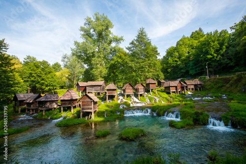 Schilderij op canvas Scenic view of the historical Mlincici wooden watermills on Pliva River surround