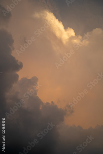 Dramatic clouds illuminated by soft sunset hues, creating an ethereal sky.
