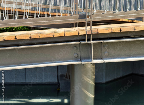 Elevated walkway steel beam structure with connection joint detail.