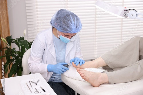 Photography Woman undergoing toenail treatment during visit to podiatrist in clinic, closeup