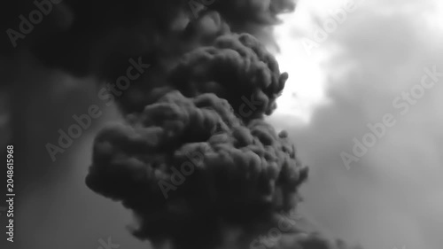 Dramatic billowing black smoke against a cloudy background abstract concept