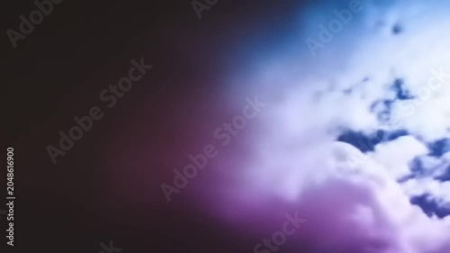 Dramatic cloud formation with purple and blue hues in a dark sky