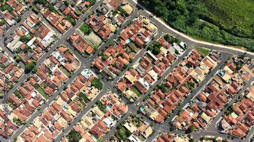 Aerial View of a Residential Neighborhood with Red Tiled Roofs and Green Trees
