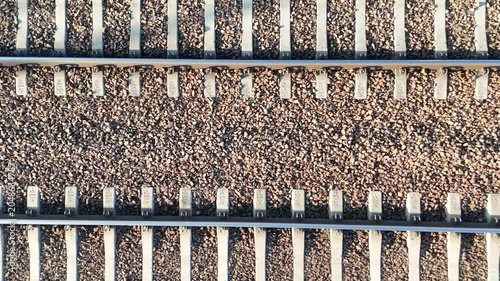 Aerial view of railway tracks showing continuous alignment of metal rails and gravel bed, highlighting the progression of rail infrastructure in a transportation setting