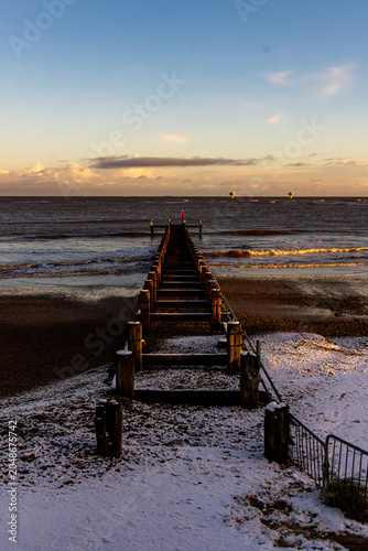 Tableau sur toile Snow-Covered sea groynes at Lowestoft Beach, Suffolk Coast